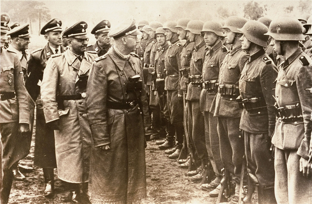 ap foto : uncredited : the june 3, 1944 photo provided by the u.s. holocaust memorial museum, heinrich himmler, ss reichsfuehrer-ss, head of the gestapo and the waffen-ss, and minister of the interior of nazi germany from 1943 to 1945, center, reviews troops of the galician ss-volunteer infantry division. in june, an associated press investigation revealed that michael karkoc, who has been living in the u.s. since 1949, was a commander in the ss-led ukrainian self defense legion. the report indicated that karkoc was in the area of massacres, but found no records linking him to atrocities. a newly unearthed investigative file reveals that a private under karkoc's command testified that karkoc ordered the assault on chlaniow in retaliation for the slaying of an ss major, contradicting claims by the man's family that he was never at the scene of the civilian massacre. karkoc became a member of the galician division after the ukrainian self defense legion was incorporated into it near the end of the war.  (ap photo/ u.s. holocaust memoxñ ap provides access to this publicly distributed handout photo provided the us holocaust memorial museu germany us nazi commande automatarkiverad