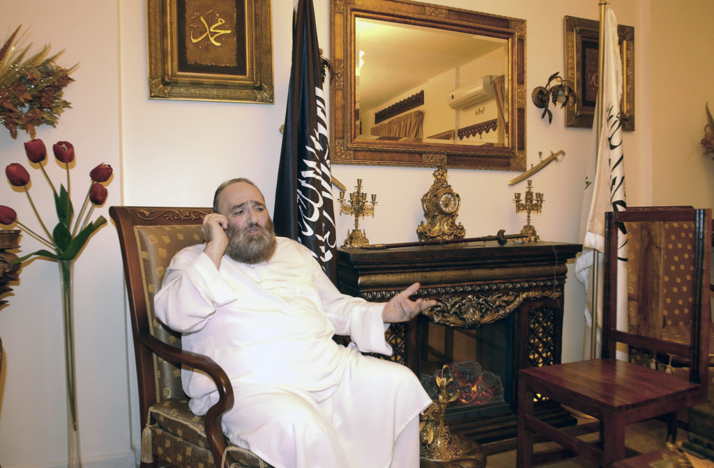 ap foto : str : muslim cleric omar bakri mohammed speaks on a mobile phone, during an interview with the associated press in his house in the northern city of tripoli, lebanon, friday, nov. 12, 2010.  a military court in lebanon on friday convicted radical muslim cleric omar bakri mohammed of terrorism charges and sentenced him in absentia to life in prison, according to lebanese judicial officials, who said bakri was among 54 people sentenced friday as part of ongoing trials of militants who fought deadly clashes with the lebanese army in 2007. (ap photo) omar bakri mohamme mideast lebanon cleric sentence automatarkiverad