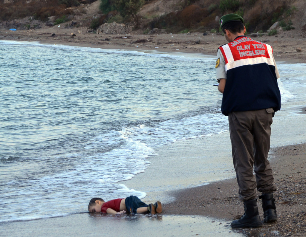 ap foto : nilufer demir : file - in this wednesday, sept. 2, 2015 file photo, a paramilitary police officer investigates the scene before carrying the body of 3-year-old aylan kurdi from the sea shore, near the beach resort of bodrum, turkey. have we hardened so much, so fast? five months ago, a 3-year-old syrian boyís corpse on a turkish beach galvanized public action. now, strikingly similar images are generating little more than a collective shrug. (nilufer demir/dha via ap, file) turkey out sept. 2, 2015 file photo. eds note: graphic content; turkey ou turkey migrants hardenin automatarkiverad alan kurdi